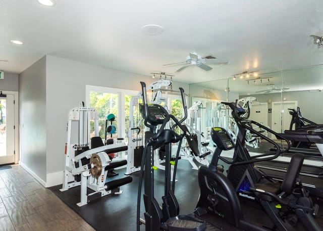 Fitness center with cardio machines and weight training equipment.