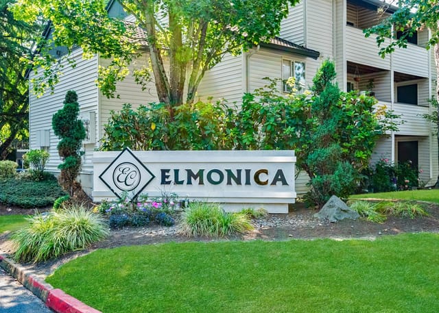 Elmonica apartment complex monument sign with landscaping.