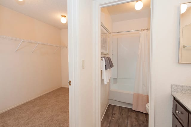 Closet and bathroom with shower and toilet