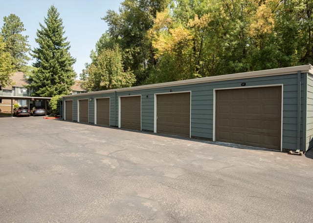 Row of garage doors with numbered signs.