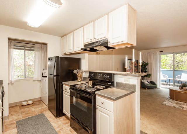 Kitchen with black appliances and white cabinets.