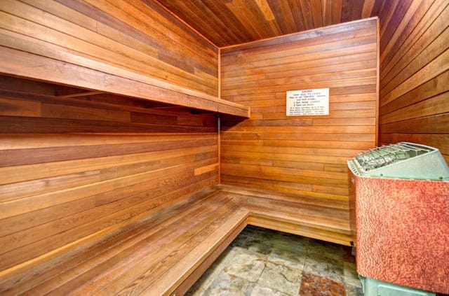 Interior of a wooden sauna with benches and a heater.