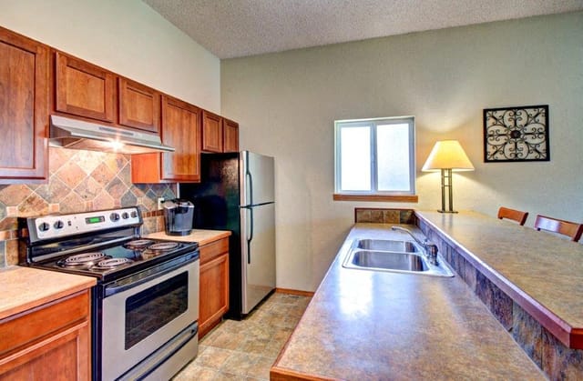 Modern kitchen with stainless steel appliances and wood cabinetry