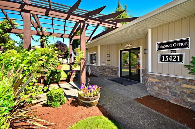 Leasing office entrance with signage and outdoor pergola.