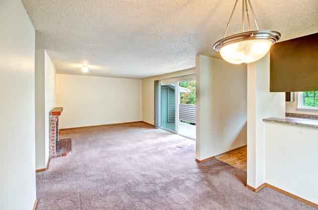 Living room with fireplace and sliding glass door leading to balcony