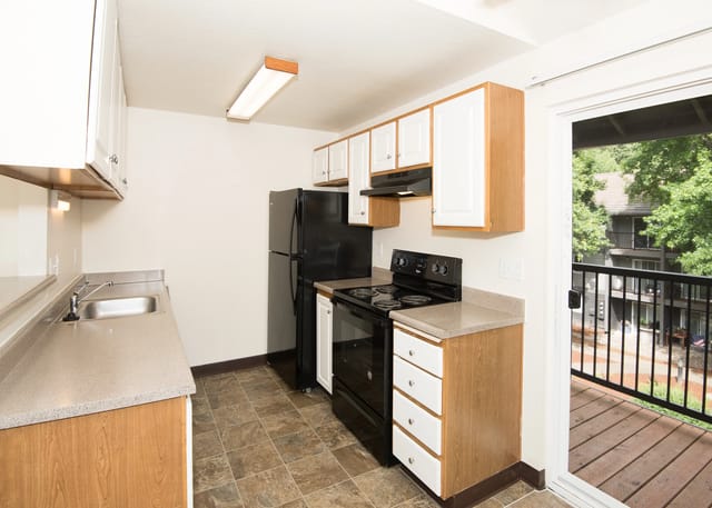 Kitchen with black appliances and white cabinets
