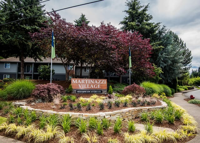 Signage for Martinazzi Village apartment complex with address 8010-8090 SW Avery St.