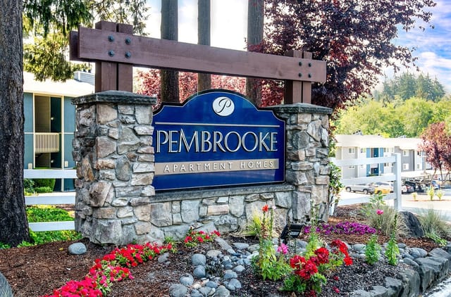 Pembroke Apartment Homes monument sign with stone pillars and landscaping.