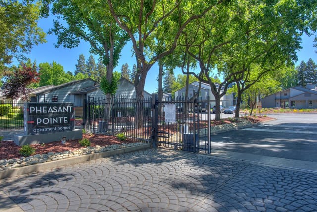 Pheasant Pointe apartment homes entrance gate with monument sign.