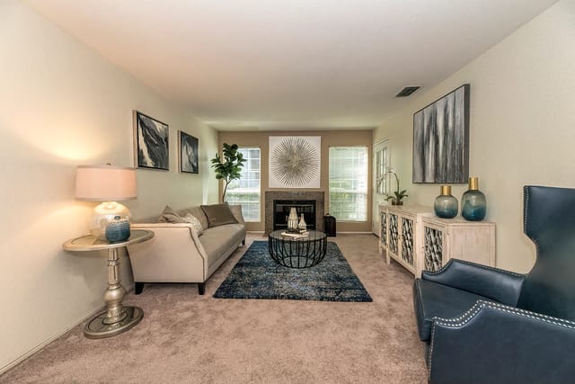 Living room with a fireplace, couch, and decorative accents.