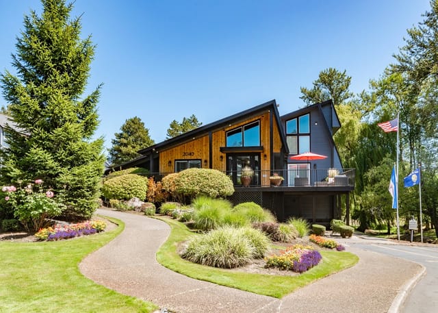 Exterior view of the property's modern building with a winding pathway and landscaping.