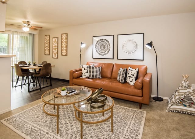 Living room with a sofa, coffee table, dining area, and a teepee.