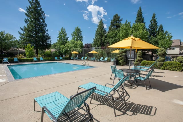 Swimming pool with lounge chairs and umbrellas
