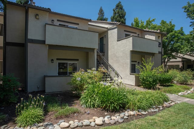 Exterior view of apartment building with stairs and landscaping