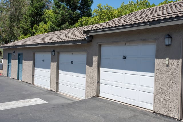 Exterior view of garage doors with numbers 01 and 02.