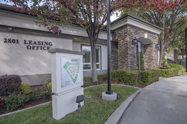 Exterior view of the leasing office with address 2801 and a site map displayed.