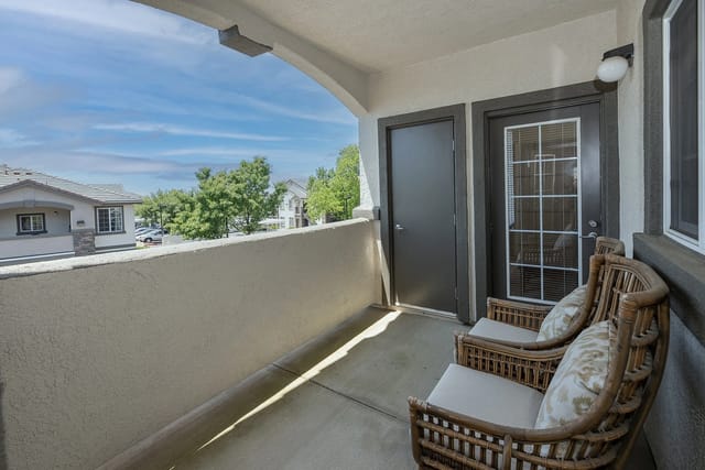 Balcony with two chairs and view of community