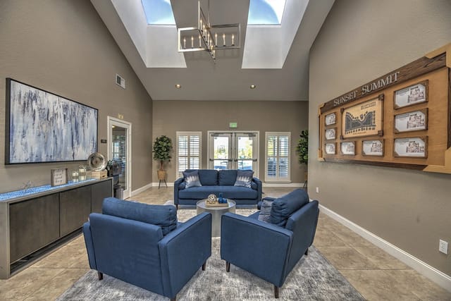 The leasing office or community lounge with blue seating and a map of the property.