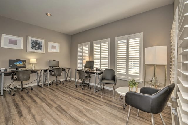 Business center with desks, computers, and chairs.
