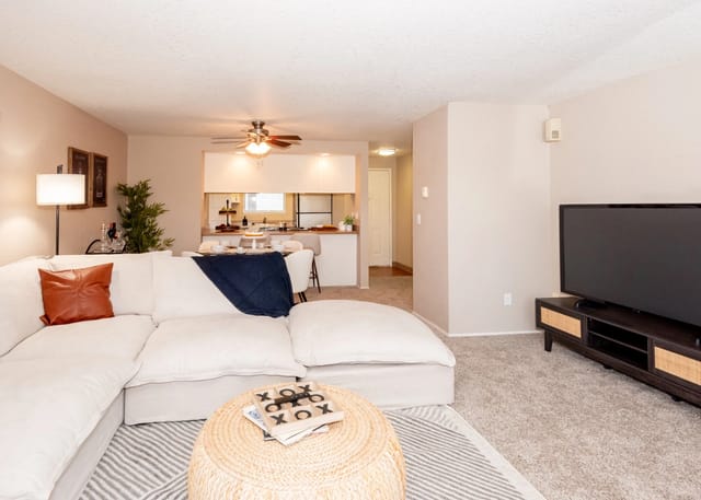 Spacious living room with a large sectional sofa, coffee table, and TV.