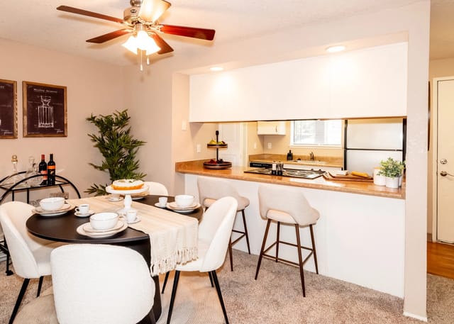 Dining area and kitchen with breakfast bar and bar stools