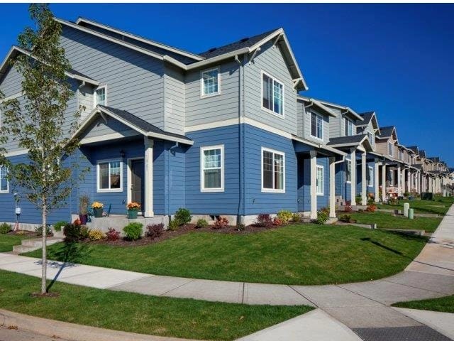 Row of townhomes with blue and grey siding.