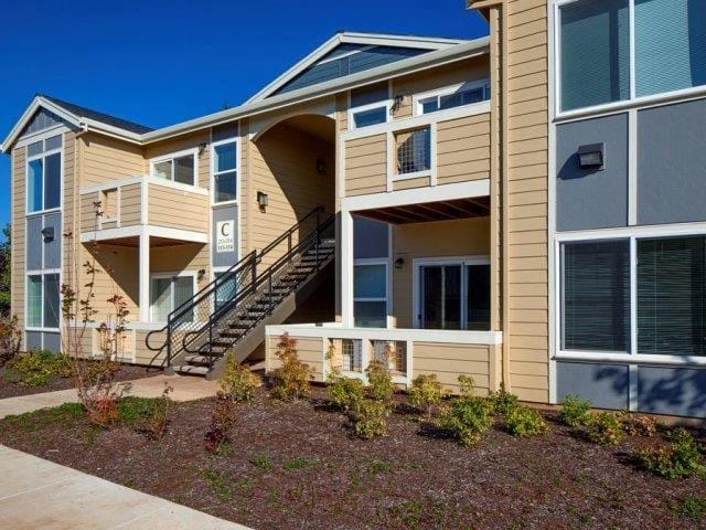 Exterior building entrance with stairs at a multifamily property.