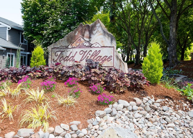 Signage for Todd Village with surrounding landscaping.