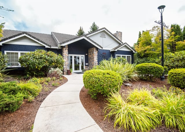 Exterior view of building entrance with landscaping.