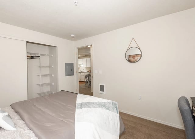Bedroom with a bed, closet, and access to the kitchen.