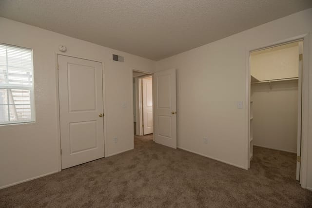 Bedroom with two doors and a closet