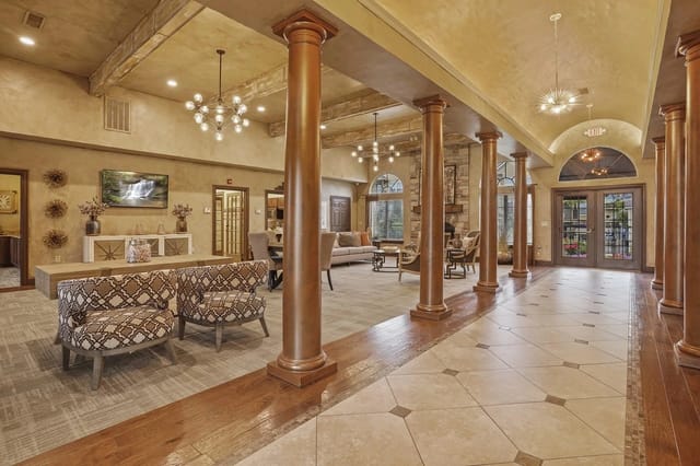 Elegant apartment community lounge area with seating and decor.