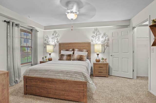 Bedroom with a king-sized bed, two nightstands with lamps, and a closet.