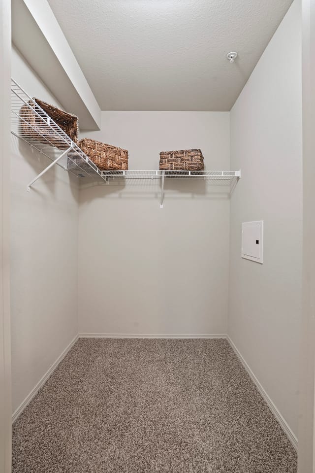 Empty closet with wire shelving and storage baskets