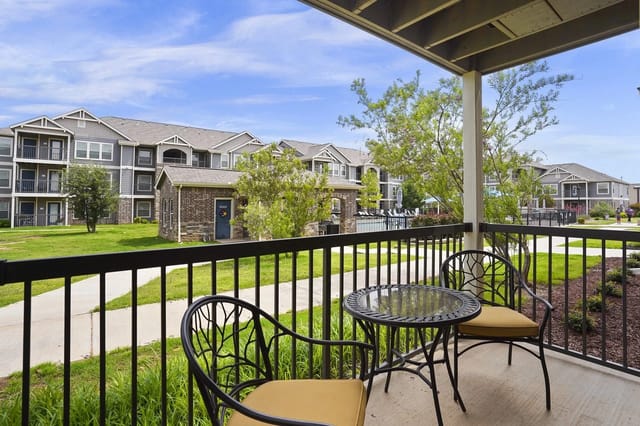 Balcony view of apartment buildings and pool area