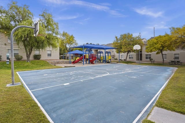 Basketball court and playground at apartment complex.
