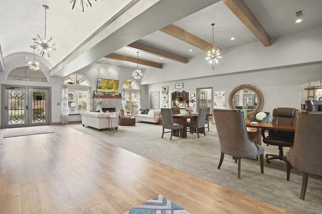 Spacious community lobby with sofas, tables, and modern lighting.