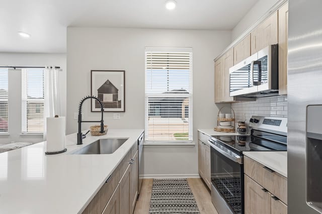 Modern kitchen with stainless steel appliances and ample counter space.