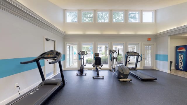 Fitness center with treadmills, ellipticals, and stationary bikes.