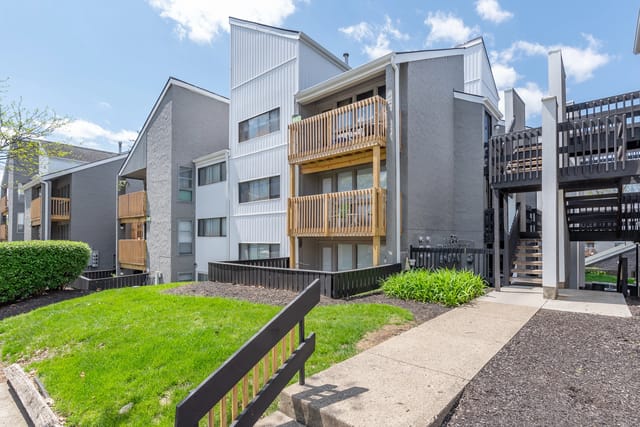 Exterior view of apartment buildings with balconies and stairs.