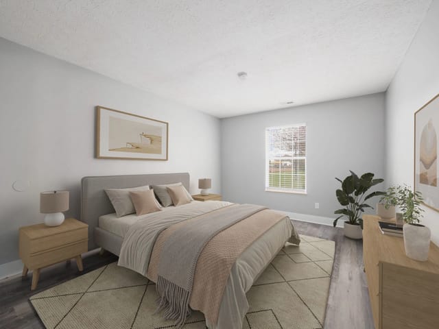 Bedroom with a king-size bed, bedside tables, and a dresser.