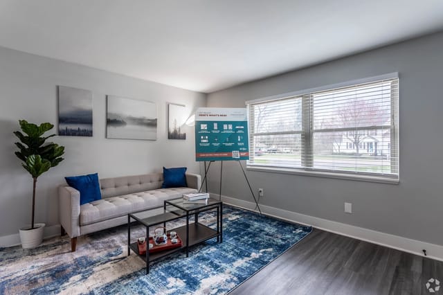 Living room with sofa, coffee table, and artwork.
