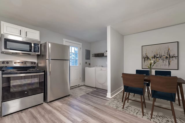 Modern kitchen with stainless steel appliances and dining area