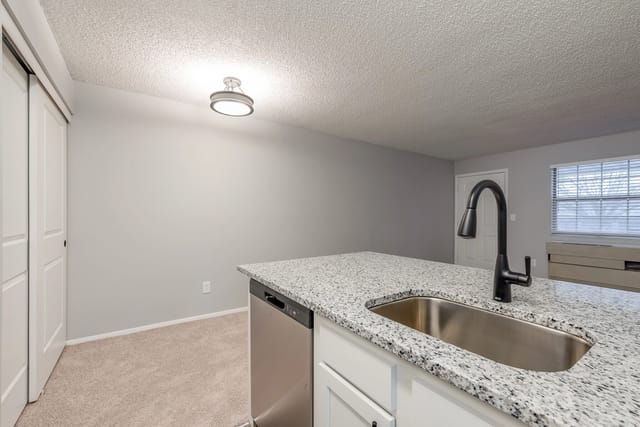 Kitchen island with sink and faucet.