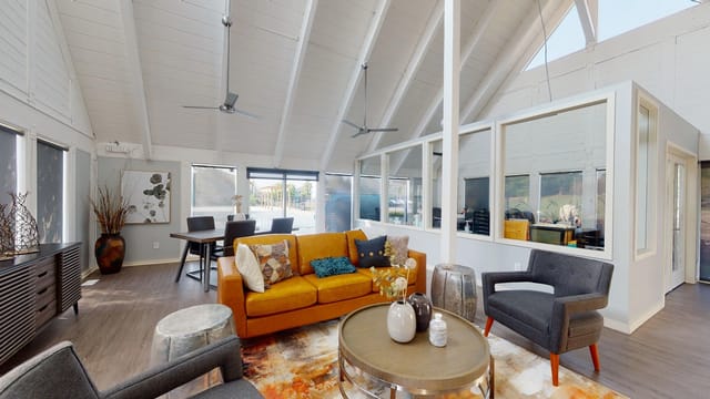 Clubhouse lounge area with a large orange sofa, coffee table, and seating.