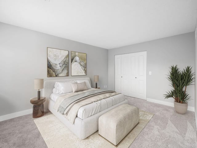 Bedroom with a king-size bed, bedside tables, and a closet.