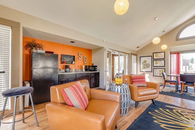 Community lounge area with kitchenette, seating, and dining table.