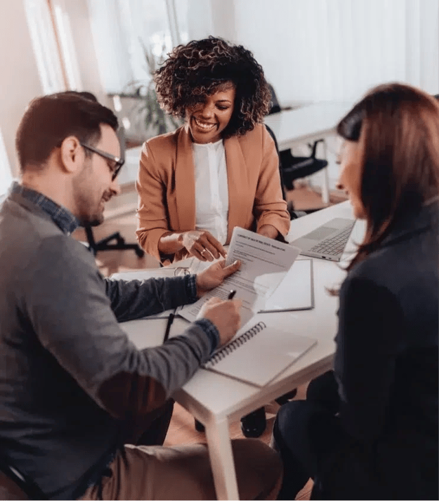 Modern kitchen with stainless steel appliances, white cabinets, and marble countertops.