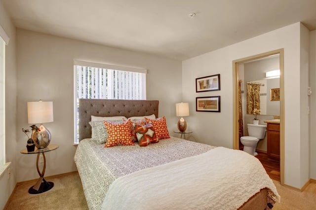 Cozy bedroom with a large bed and an en-suite bathroom.