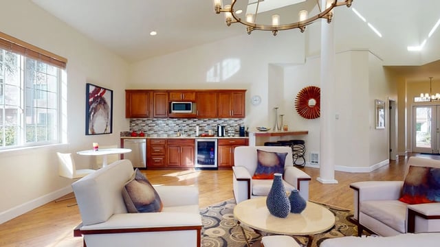 Modern living space with a kitchen, seating area, and dining nook.